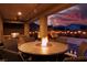 Outdoor patio with fire pit table and seating near the pool at 10936 White Alder Pl, Las Vegas, NV 89138