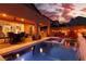 Outdoor dining area with fire pit and adjacent pool; mountain view at 10936 White Alder Pl, Las Vegas, NV 89138