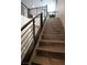 Modern staircase with metal railing and hardwood steps at 10936 White Alder Pl, Las Vegas, NV 89138