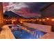 Resort-style pool and spa accented by string lights and waterfall feature create a relaxing outdoor oasis at 10936 White Alder Pl, Las Vegas, NV 89138