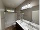 Secondary bathroom with double vanity and shower/tub combo at 11106 Cherokee Landing St, Las Vegas, NV 89179