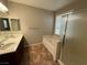 Bathroom with double vanity, tub, and shower at 11106 Cherokee Landing St, Las Vegas, NV 89179