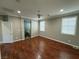 Main bedroom with wood-look floors and access to bathroom at 11106 Cherokee Landing St, Las Vegas, NV 89179