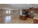 Open kitchen with granite countertops, island, dark wood cabinets, and tile backsplash at 11106 Cherokee Landing St, Las Vegas, NV 89179