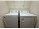 Laundry room with washer, dryer, and overhead shelving at 11106 Cherokee Landing St, Las Vegas, NV 89179