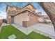 Two-story house with a brown garage door and artificial turf at 11157 Sandrone Ave, Las Vegas, NV 89138