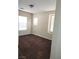 Simple bedroom with brown carpet and two windows at 11185 Saddle Iron St, Las Vegas, NV 89179