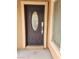 Dark brown front door with a glass oval window at 11185 Saddle Iron St, Las Vegas, NV 89179