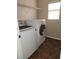 Bright laundry room features washer, dryer, and overhead shelving at 11185 Saddle Iron St, Las Vegas, NV 89179