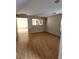 Living room with wood-look flooring and open view to kitchen at 11185 Saddle Iron St, Las Vegas, NV 89179