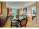 Elegant dining area with glass table and four chairs, adjacent to living room at 125 E Harmon Ave # 1702, Las Vegas, NV 89109