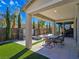 Covered patio with seating area, water feature, and fire pit at 12846 Ringrose St, Las Vegas, NV 89141