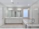 Elegant bathroom with double vanity, soaking tub and glass shower at 12846 Ringrose St, Las Vegas, NV 89141