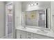 Bathroom with double vanity, quartz countertop and a shower at 12846 Ringrose St, Las Vegas, NV 89141