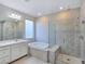 Spa-like bathroom featuring a soaking tub, walk-in shower, and double vanity at 12846 Ringrose St, Las Vegas, NV 89141