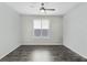 Spacious bedroom with dark gray vinyl flooring and window shutters at 12846 Ringrose St, Las Vegas, NV 89141