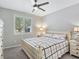 Bright bedroom with a queen bed, window shutters, and carpeted floor at 12846 Ringrose St, Las Vegas, NV 89141