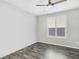 Simple bedroom with gray walls, dark gray vinyl flooring, and window shutters at 12846 Ringrose St, Las Vegas, NV 89141