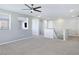 Spacious bonus room with gray carpet, open concept layout, and ceiling fan at 12846 Ringrose St, Las Vegas, NV 89141