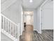 Entryway with gray wood-look floors, white staircase, and white doors at 12846 Ringrose St, Las Vegas, NV 89141