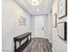 Entryway with gray wood-look floors, white walls, and a console table at 12846 Ringrose St, Las Vegas, NV 89141