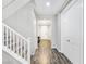 Entryway with gray wood-look floors, white staircase, and white doors at 12846 Ringrose St, Las Vegas, NV 89141