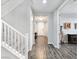 Entryway with gray wood-look floors, white staircase, and white doors at 12846 Ringrose St, Las Vegas, NV 89141