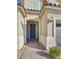 Front entrance with a dark gray door and brick walkway at 12846 Ringrose St, Las Vegas, NV 89141