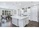 Modern kitchen with white cabinets, a large island and hardwood floors at 12846 Ringrose St, Las Vegas, NV 89141