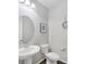 Small powder room with white pedestal sink and toilet at 12846 Ringrose St, Las Vegas, NV 89141