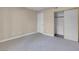 Bedroom with gray carpeting and mirrored closet doors at 1575 W Warm Springs Rd # 911, Henderson, NV 89014