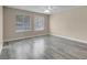 Bright bedroom with gray vinyl flooring and two windows at 1575 W Warm Springs Rd # 911, Henderson, NV 89014