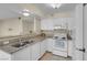 Well-equipped kitchen featuring granite countertops and white cabinets at 1575 W Warm Springs Rd # 911, Henderson, NV 89014