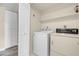 Laundry room with washer, dryer, and shelving at 1575 W Warm Springs Rd # 911, Henderson, NV 89014