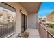 Private patio with metal railing, sliding glass door, and small table at 1575 W Warm Springs Rd # 911, Henderson, NV 89014