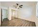 Bright bedroom with mirrored closet doors and wood-look floors at 1688 Crest Ave, Las Vegas, NV 89119