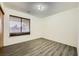 Bedroom with wood-look floors and window with blinds at 1688 Crest Ave, Las Vegas, NV 89119