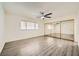 Bright bedroom with mirrored closet doors and ceiling fan at 1688 Crest Ave, Las Vegas, NV 89119