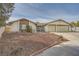 Single-story house with a two-car garage and landscaped front yard at 1688 Crest Ave, Las Vegas, NV 89119