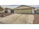 Two-car garage and front yard of single-story house at 1688 Crest Ave, Las Vegas, NV 89119