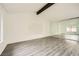 Bright living room with vaulted ceiling, wood floors, and large window at 1688 Crest Ave, Las Vegas, NV 89119