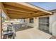 Covered patio with seating area, grill, and pool view at 1688 Crest Ave, Las Vegas, NV 89119