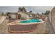 Inviting kidney-shaped pool in backyard with surrounding gravel at 1688 Crest Ave, Las Vegas, NV 89119