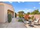 Landscaped backyard with stone patio and seating area at 2 Lago Turchino Ct, Henderson, NV 89011