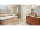 Spa-like bathroom with a soaking tub, shower, and double vanity at 2 Lago Turchino Ct, Henderson, NV 89011