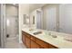 Clean bathroom with double sinks and a large mirror at 2 Lago Turchino Ct, Henderson, NV 89011