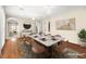 Virtually staged dining room with hardwood floors and a large marble table at 2 Lago Turchino Ct, Henderson, NV 89011