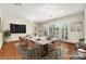 Virtually staged dining room features a large table with seating for eight and hardwood floors at 2 Lago Turchino Ct, Henderson, NV 89011