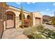 Front view of the home with a large door and landscaping at 2 Lago Turchino Ct, Henderson, NV 89011