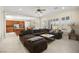 Open living room with a large sectional sofa and view of the kitchen at 2 Lago Turchino Ct, Henderson, NV 89011